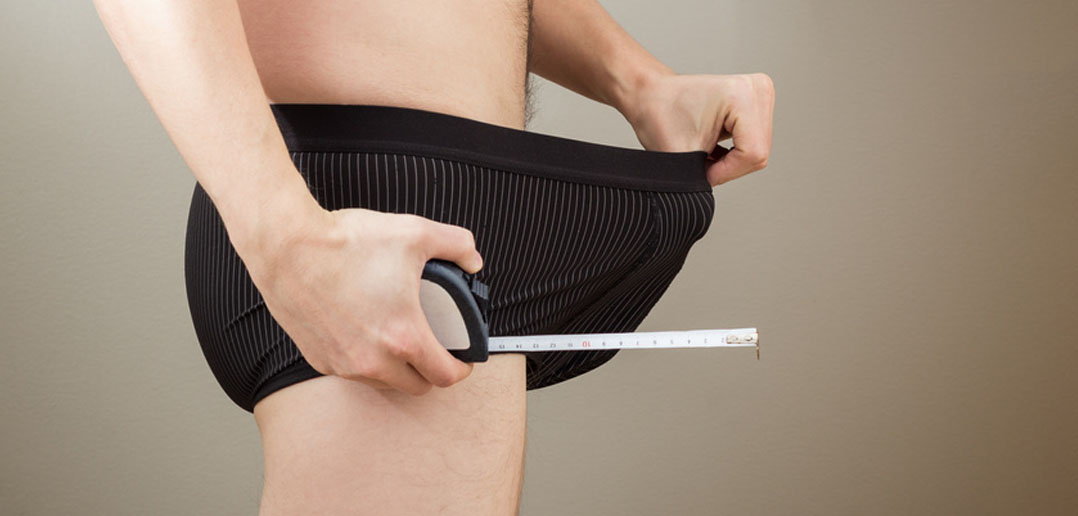 Man measuring his penis size by tuomaslehtinen